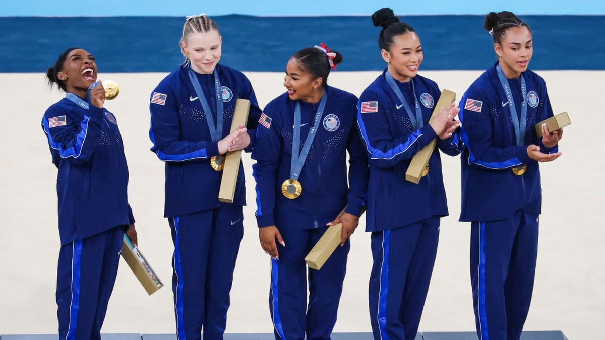 Simone Biles celebrates with Team United States teammates. GETTY IMAGES