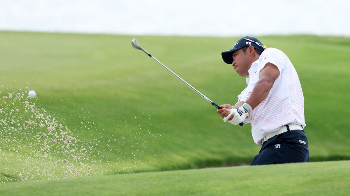 Hideki Matsuyama plays a shot from a bunker on the 18th hole. GETTY IMAGES