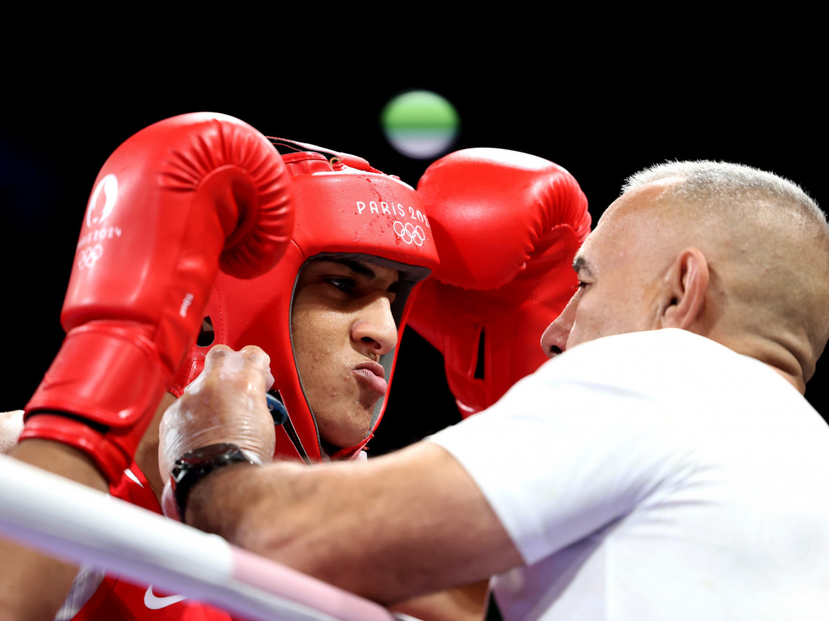 Team Algeria Coach Mohamed Al-Shawa assists Imane Khelif of Team Algeria during her Women's 66kg preliminary round match against Angela Carini of Team Italy at the Paris 2024 Olympic Games. GETTY IMAGES