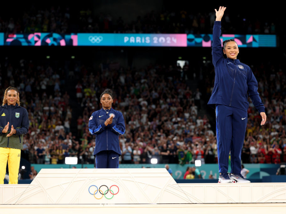 Bronze medallist Sunisa Lee celebrates on the podium. GETTY IMAGES