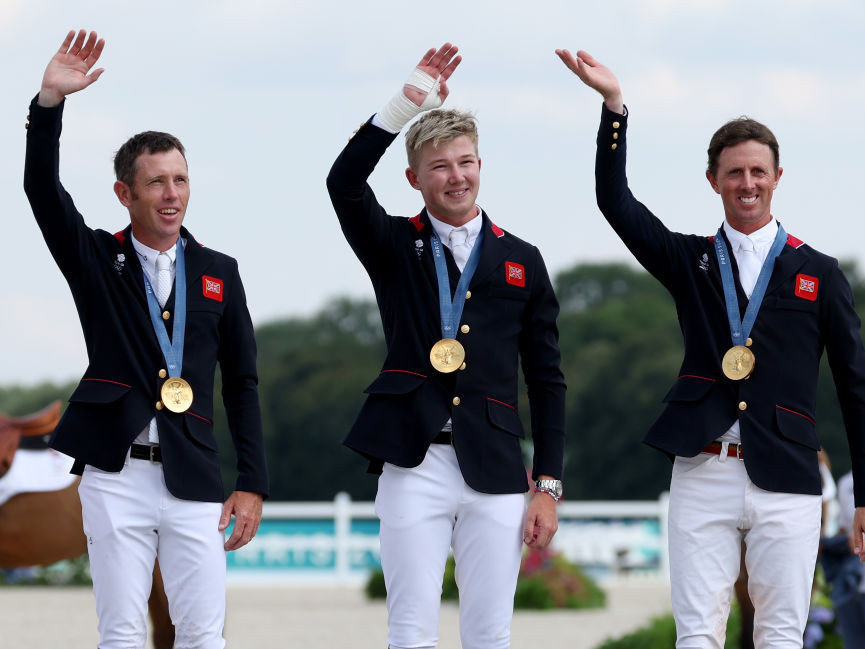 Gold medalists Scott Brash, Harry Charles and Ben Maher celebrate after the Jumping Team Final. GETTY IMAGES