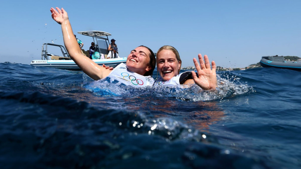Odile van Aanholt and Annette Duetz celebrate their medal from the water. GETTY IMAGES