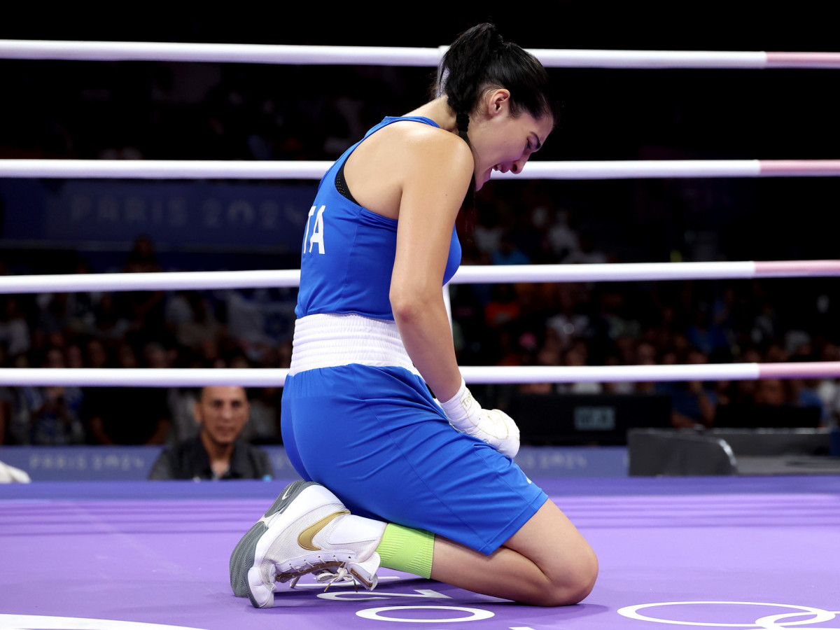 Angela Carini kneels in the ring. GETTY IMAGES