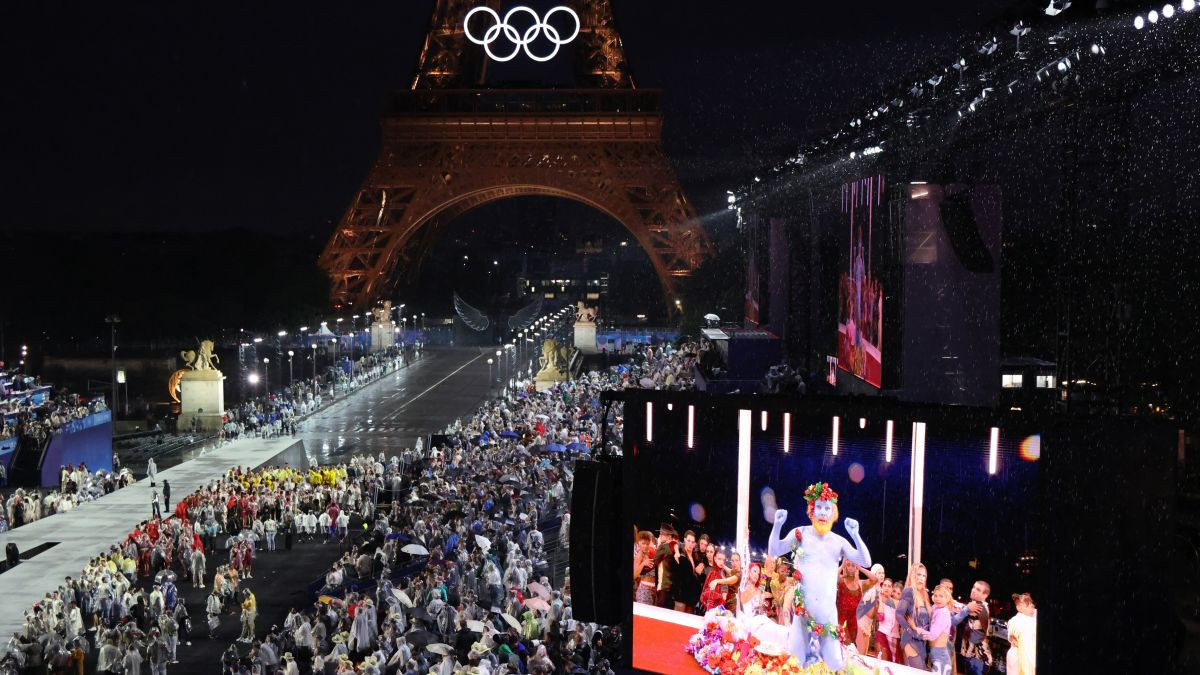 Spectators watch French singer Philippe Katerine perform on a giant screen during the opening ceremony of the Paris 2024 Olympic Games. GETTY IMAGES