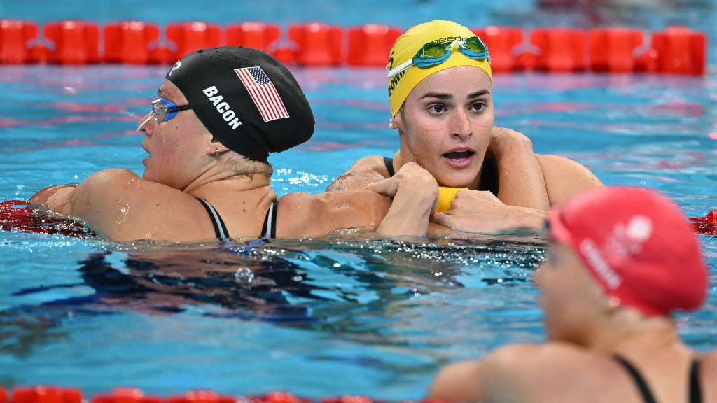 US' Phoebe Bacon (L) congratulates gold medallist Australia's Kaylee McKeown (C) after competing in the final of the women's 200m backstroke