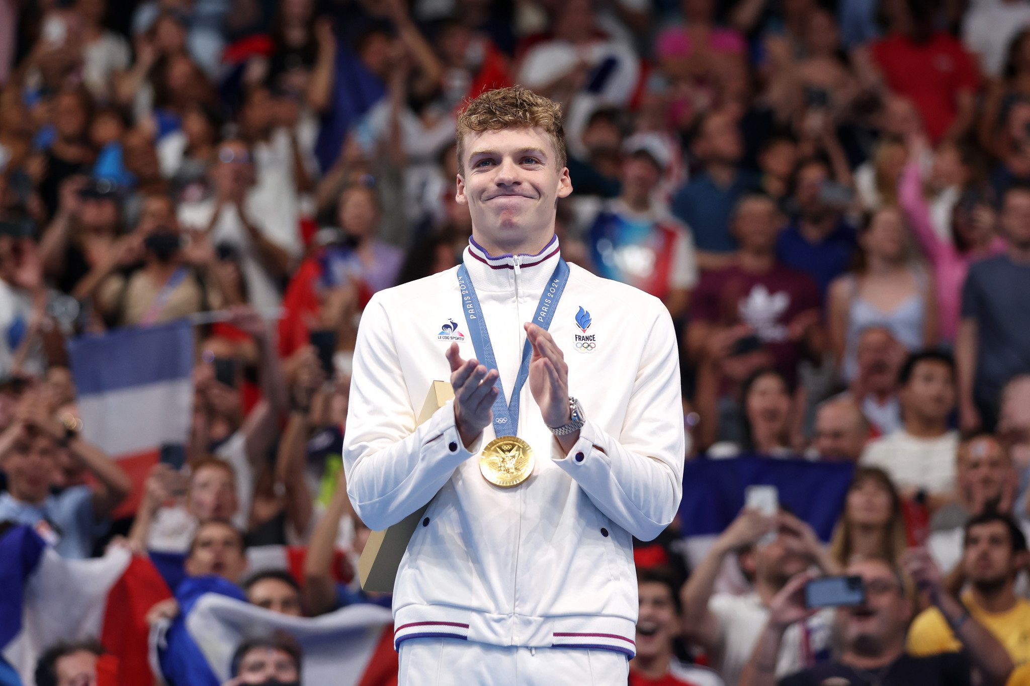 Gold Medalist Leon Marchand of Team France on the podium after the Men's 200m Individual Medley Final at the Paris 2024 Olympic Games. GETTY IMAGES