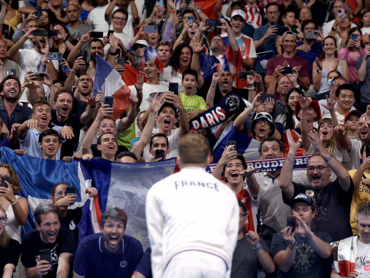 Fans show their support for Gold Medalist Leon Marchand of Team France at the Paris 2024 Olympic Games. GETTY IMAGES