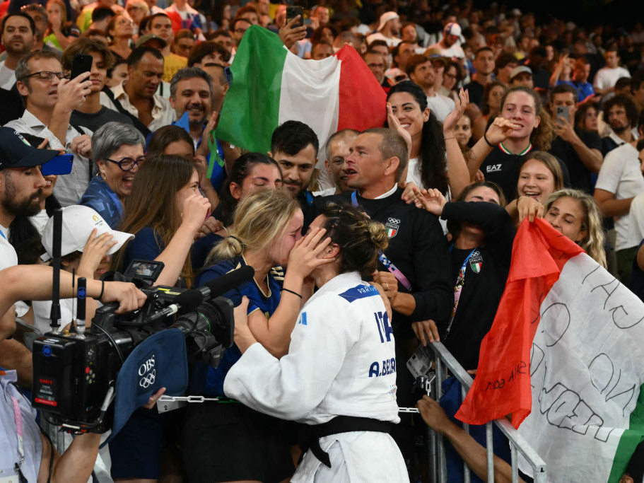 Italy's Alice Bellandi celebrates with her partner after beating Israel's Inbar Lanir. GETTY IMAGES