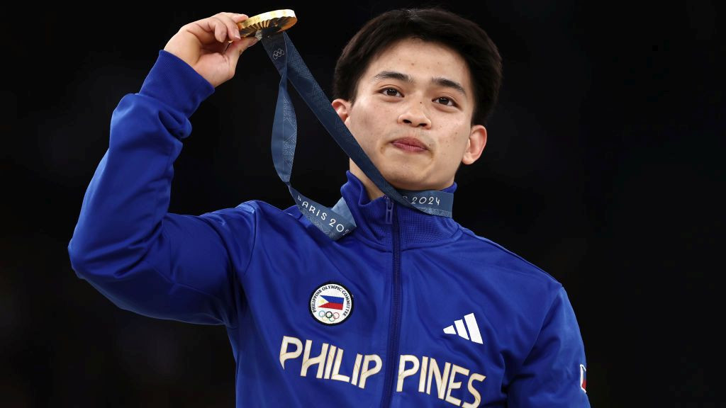 Gold medalist Carlos Edriel Yulo of Team Philippines celebrates on the podium . GETTY IMAGES