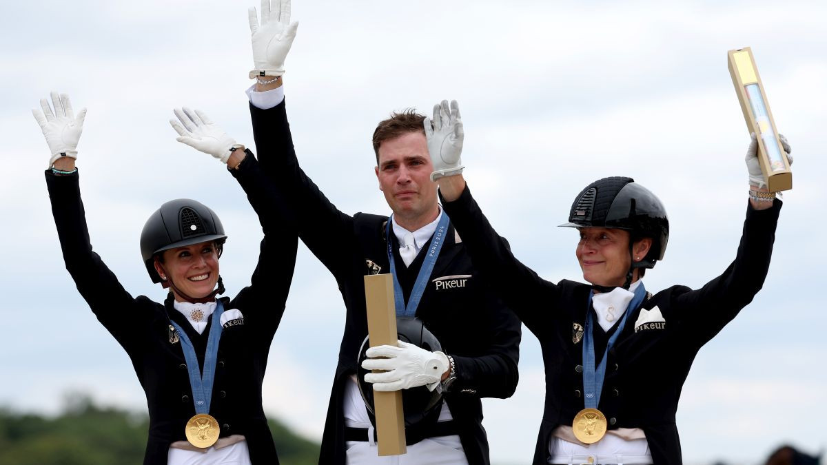 Team Germany celebrates the title of the Special Dressage Team Grand Prix. GETTY IMAGES