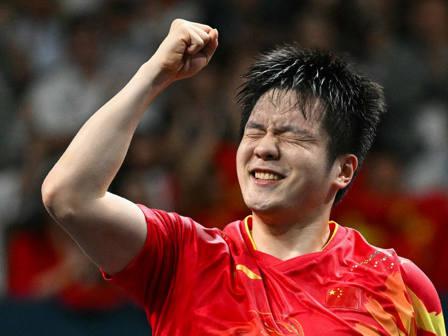 China's Fan Zhendong celebrates after winning his men's table tennis singles gold medal match. GETTY IMAGES