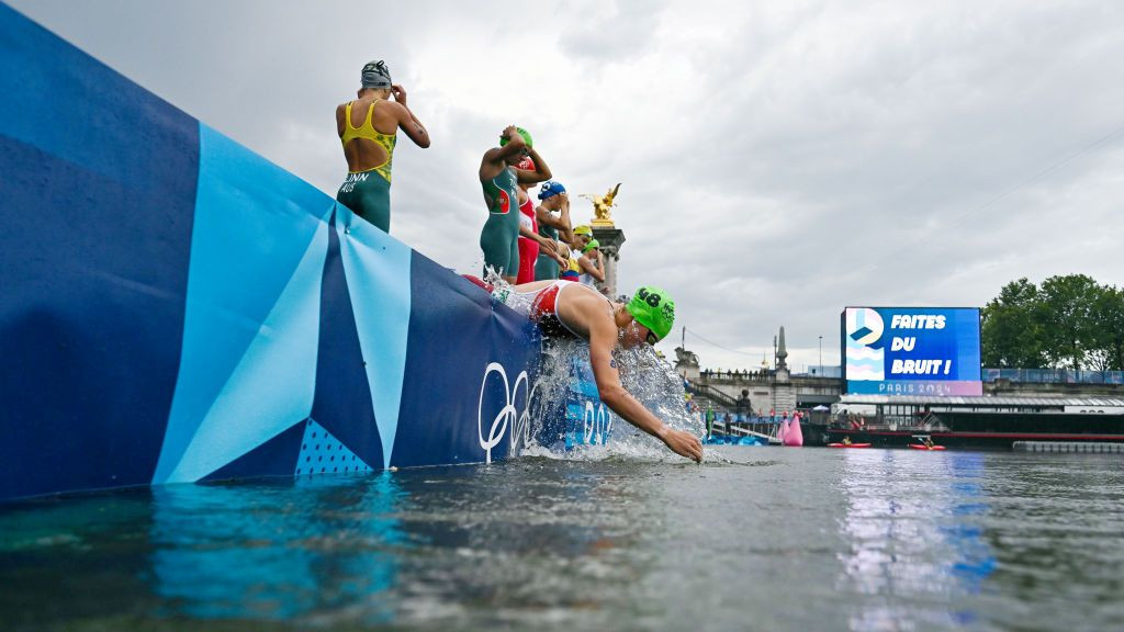 Athletes get ready to compete in the swimming race in the seine during the womens individual triathlon
