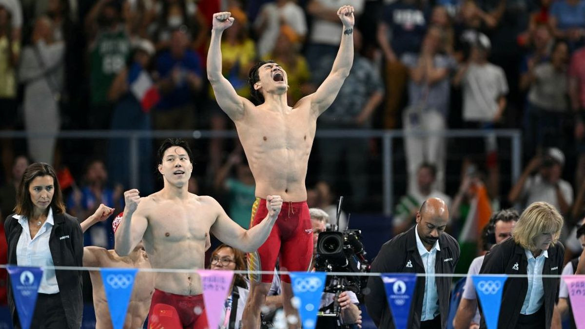 China's Qin Haiyang (L) and China's Xu Jiayu of Team China react after winning the final of the men's 4x100m medley relay. GETTY IMAGES