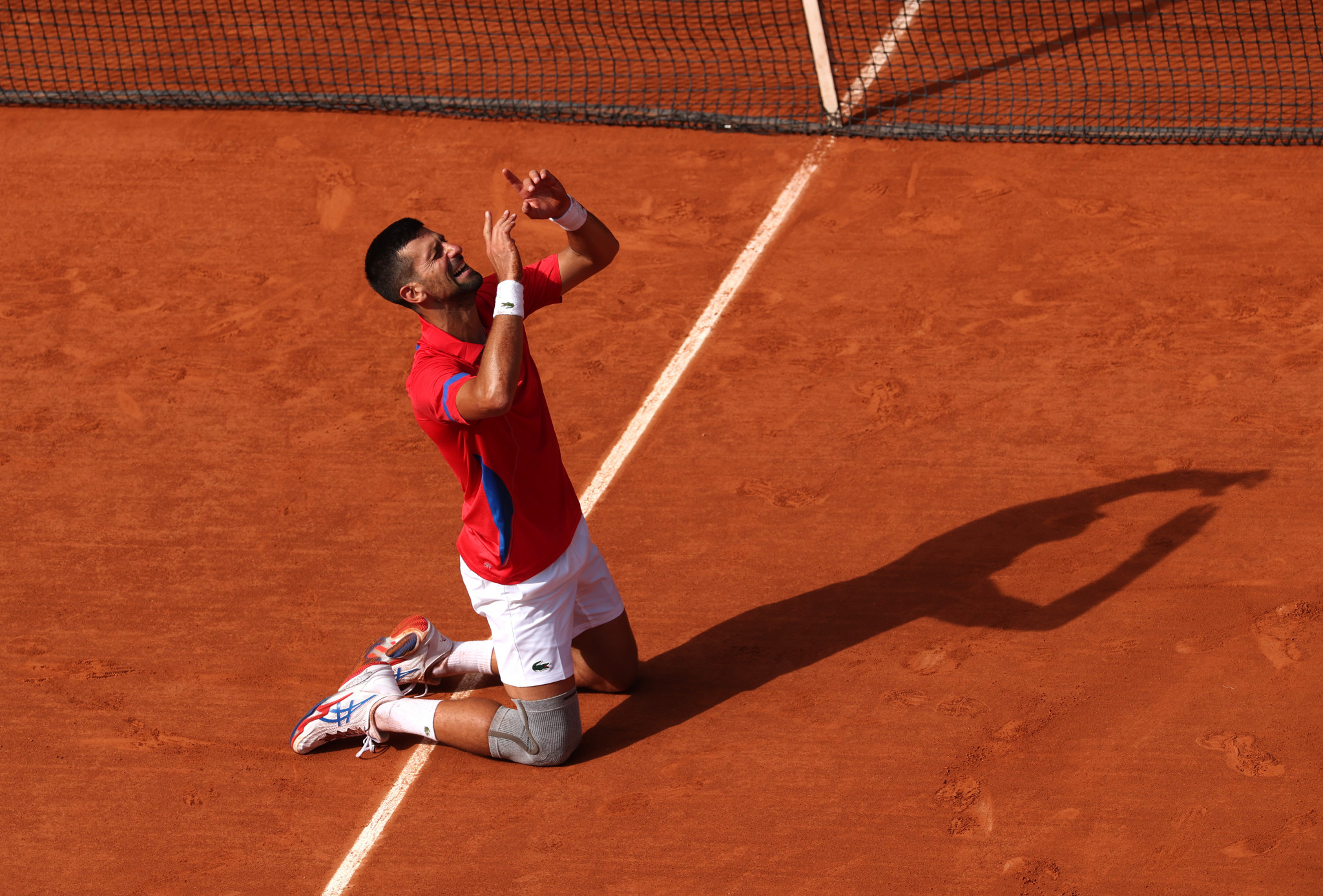 The Serbian star fell to his knees in delight. GETTY IMAGES