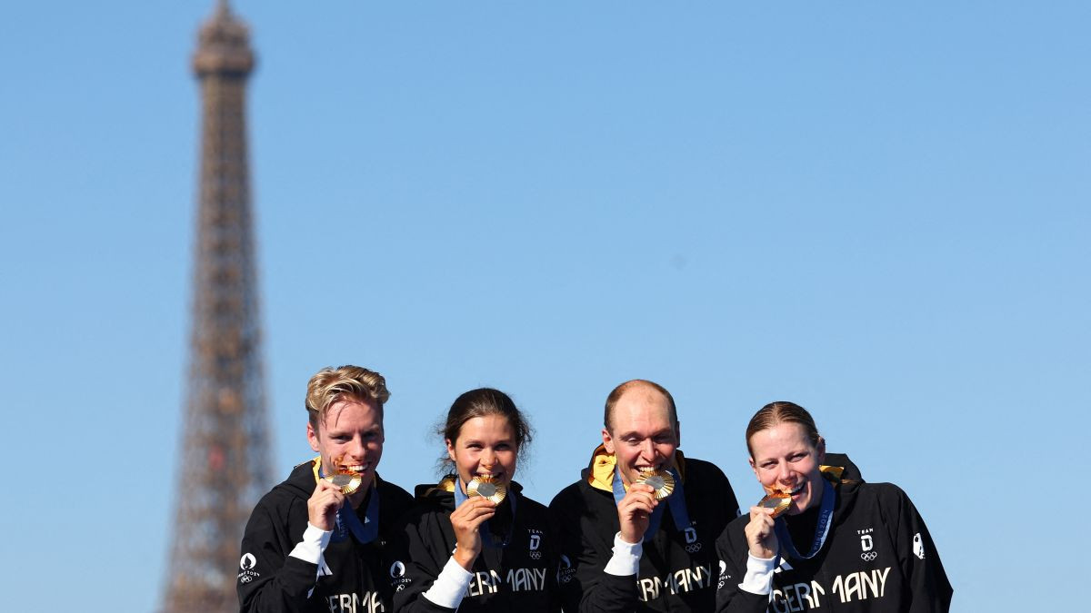 Germany's gold medallists Tim Hellwig, Lisa Tertsch, Lasse Luehrs and Laura Lindemann celebrate on the podium. GETTY IMAGES