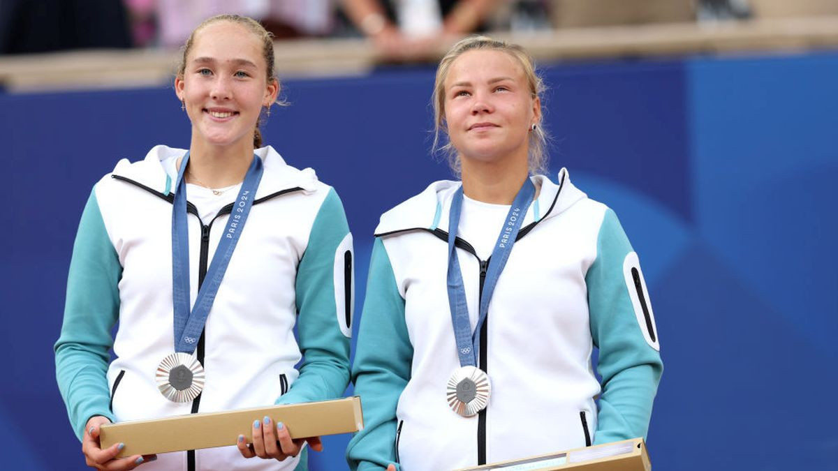 Silver Medallists, Mirra Andreeva and Diana Shnaider of Team Individual Neutral Athletes pose on the podium. GETTY IMAGES