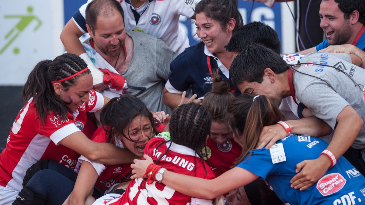 Chile's women's team celebrating the victory in the 2012 Homeless World Cup. GETTY IMAGES