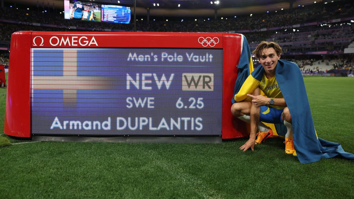 Gold medalist Armand Duplantis of Sweden poses in front of the scored board after setting a new world record. GETTY IMAGES