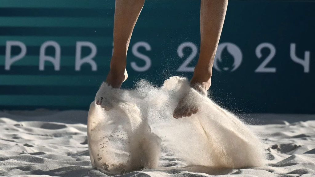 Sand falls as a player jumps for the ball. GETTY IMAGES