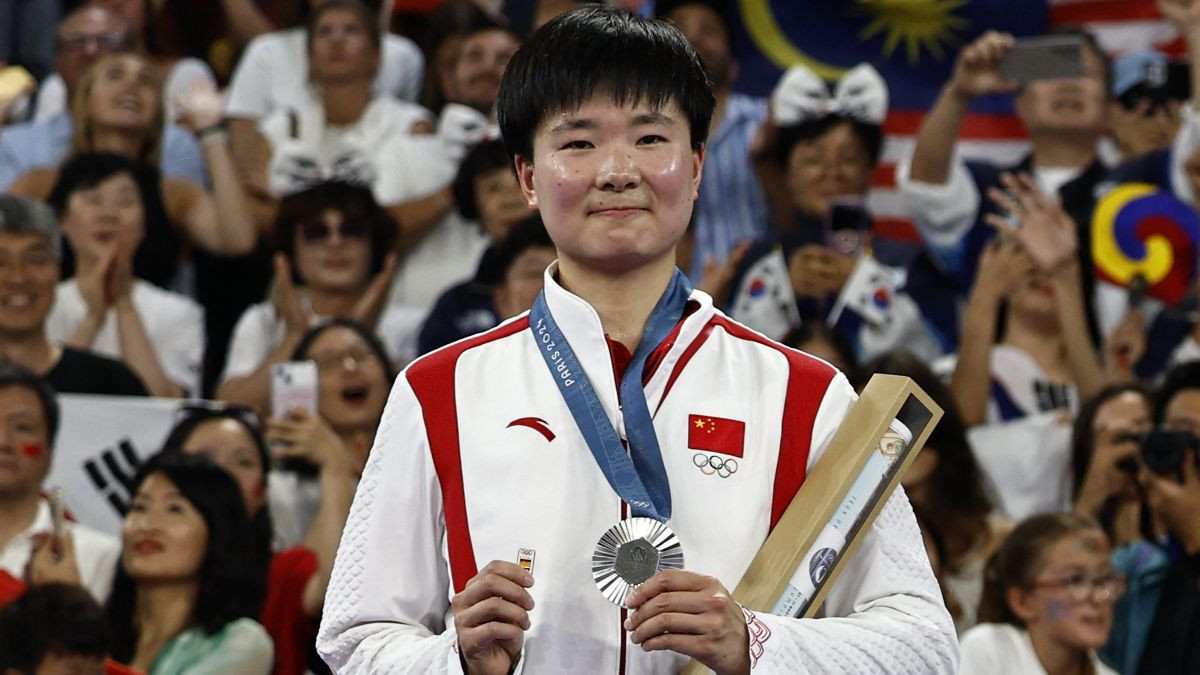 China's silver medallist He Bing Jiao celebrates with her medal on the podium at the women's singles badminton medal ceremony during the Paris 2024 Olympic Games. GETTY IMAGES