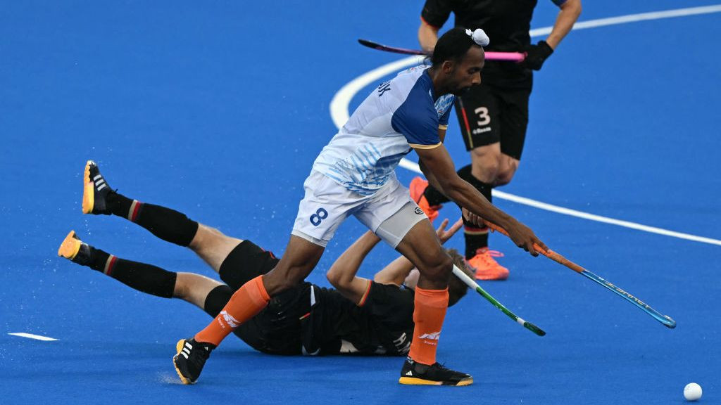 Hannes Mueller fights for the ball with India's midfielder #08 Hardik Singh in the men's semi-final field hockey. GETTY IMAGES