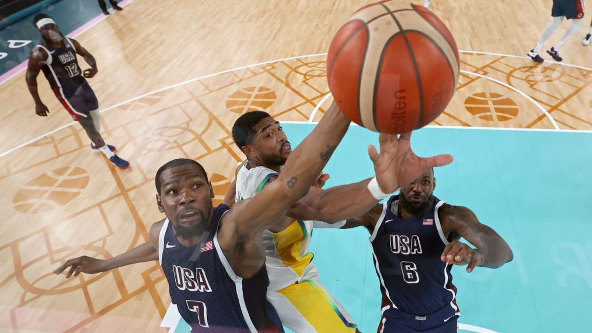 Kevin Durant and Lebron James contest for a rebound with Bruno Caboclo. GETTY IMAGES