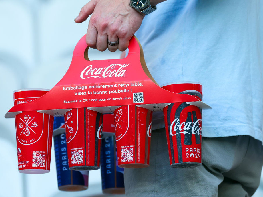 Coca-Cola stated that beverages poured into reusable cups do not count towards their plastic-reduction target for the Paris Olympics. GETTY IMAGES