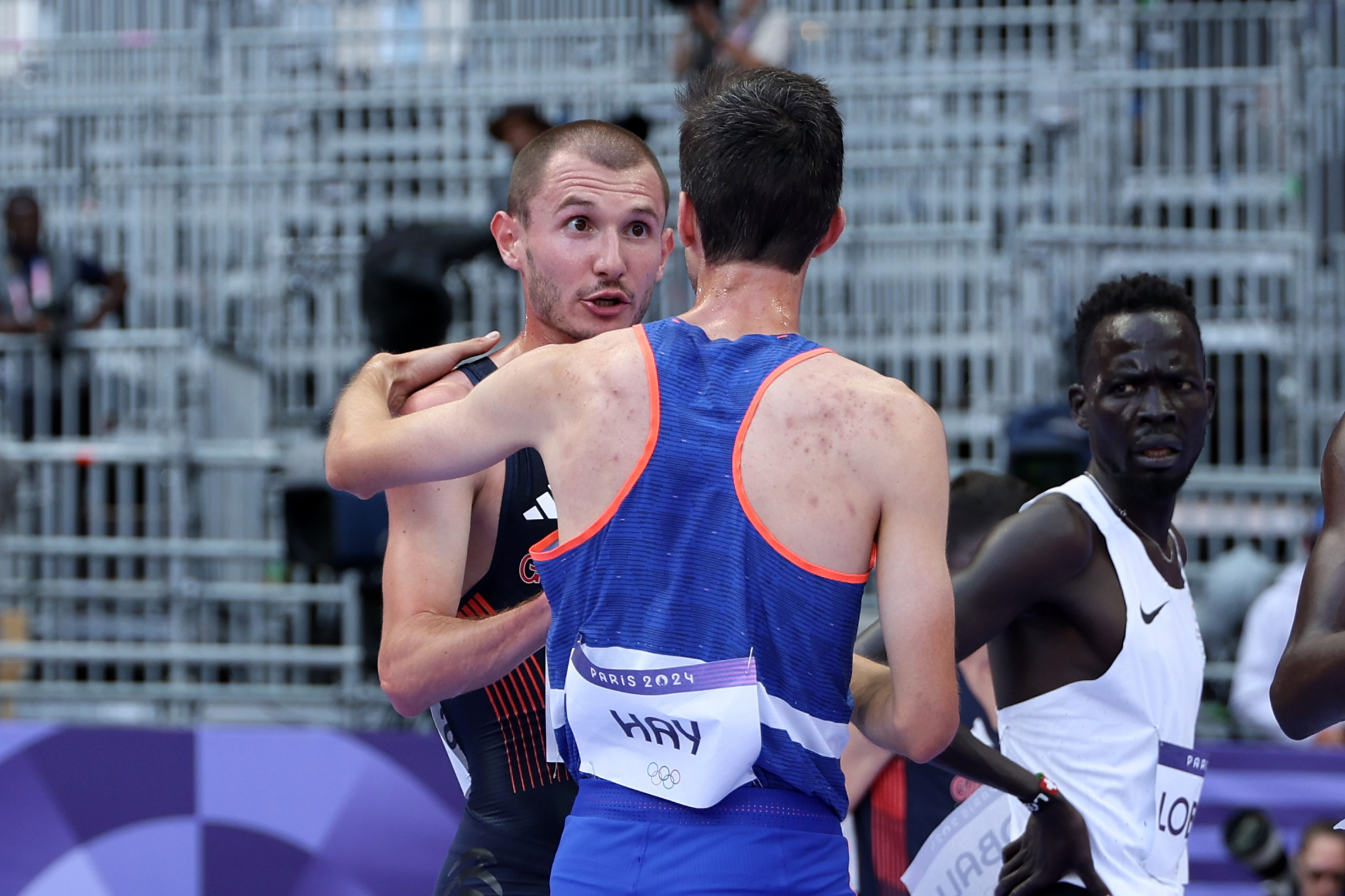 Hugo Hay of Team France and George Mills of Team Great Britain in a heated exchange after competing in the Men's 5000m Round 1 at the Paris 2024 Olympic Games. GETTY IMAGES