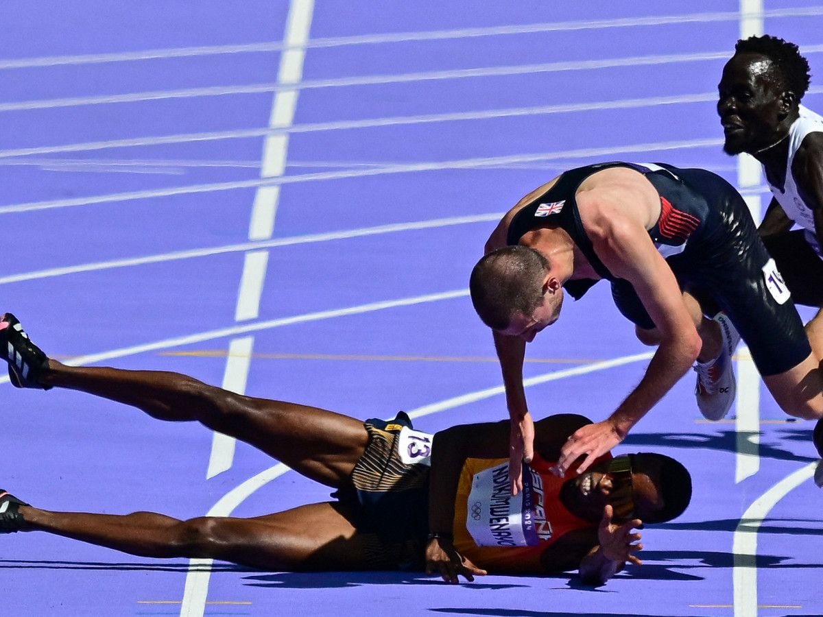 Britain's George Mills and Refugee Team's Dominic Lokinyomo Lobalu fall as they compete in the men's 5000m heat the Paris 2024 Olympic Games 