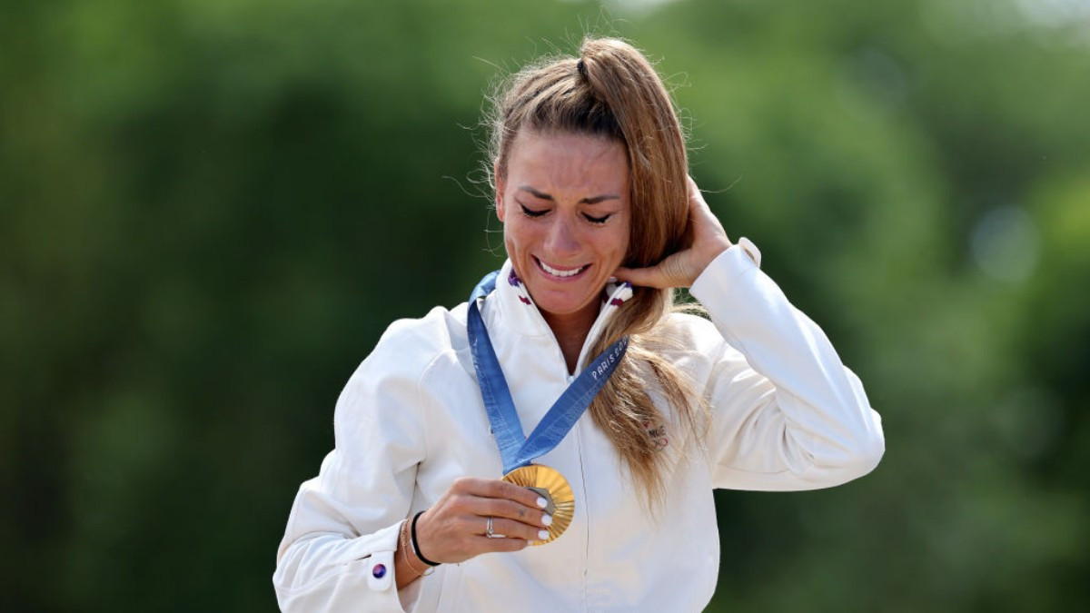 Olympic mountain bike champion Ferrand-Prevot with her gold medal on the podium in Paris. GETTY IMAGES