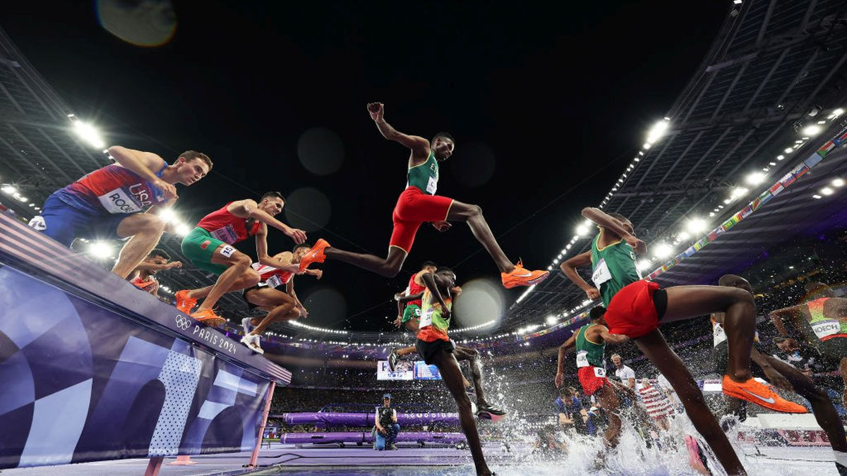 Lamecha Girma of Team Ethiopia (C) clears the water jump during the during the Men's 3000m Steeplechase Final. GETTY IMAGES