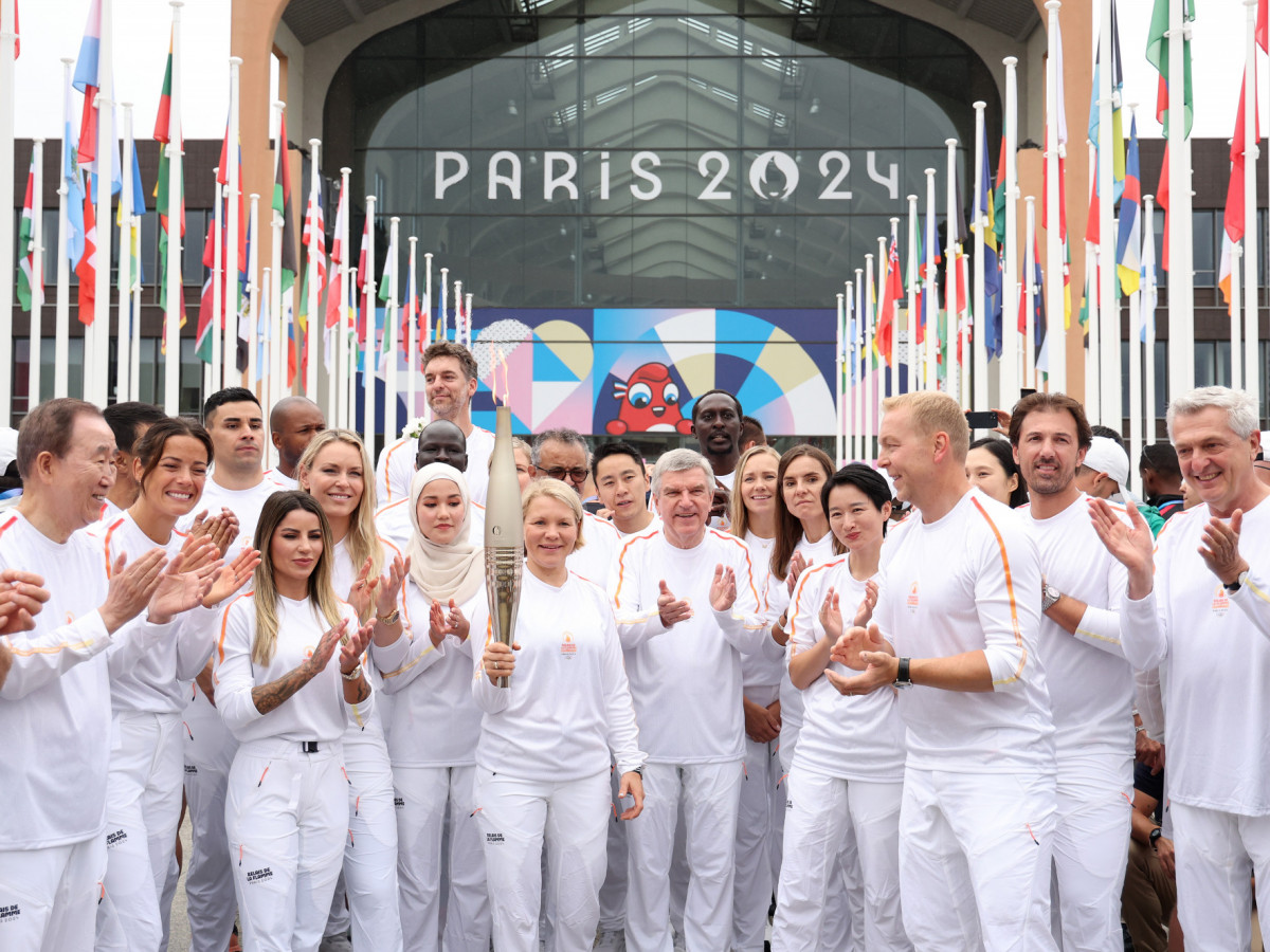 Emma Terho (CL), Chair of the IOC Athletes' Commission, Thomas Bach (C), President of the International Olympic Committee (IOC), IOC Legends and International Olympic Committee members pose during the torch relay ahead of the Summer Paris 2024 Olympic Gam