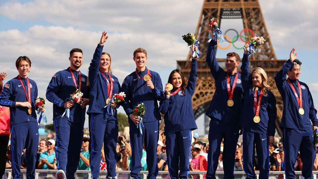 Members of the U.S. Olympic figure skating team pose for a photo after receiving gold medals following the disqualification of Russia. GETTY IMAGES