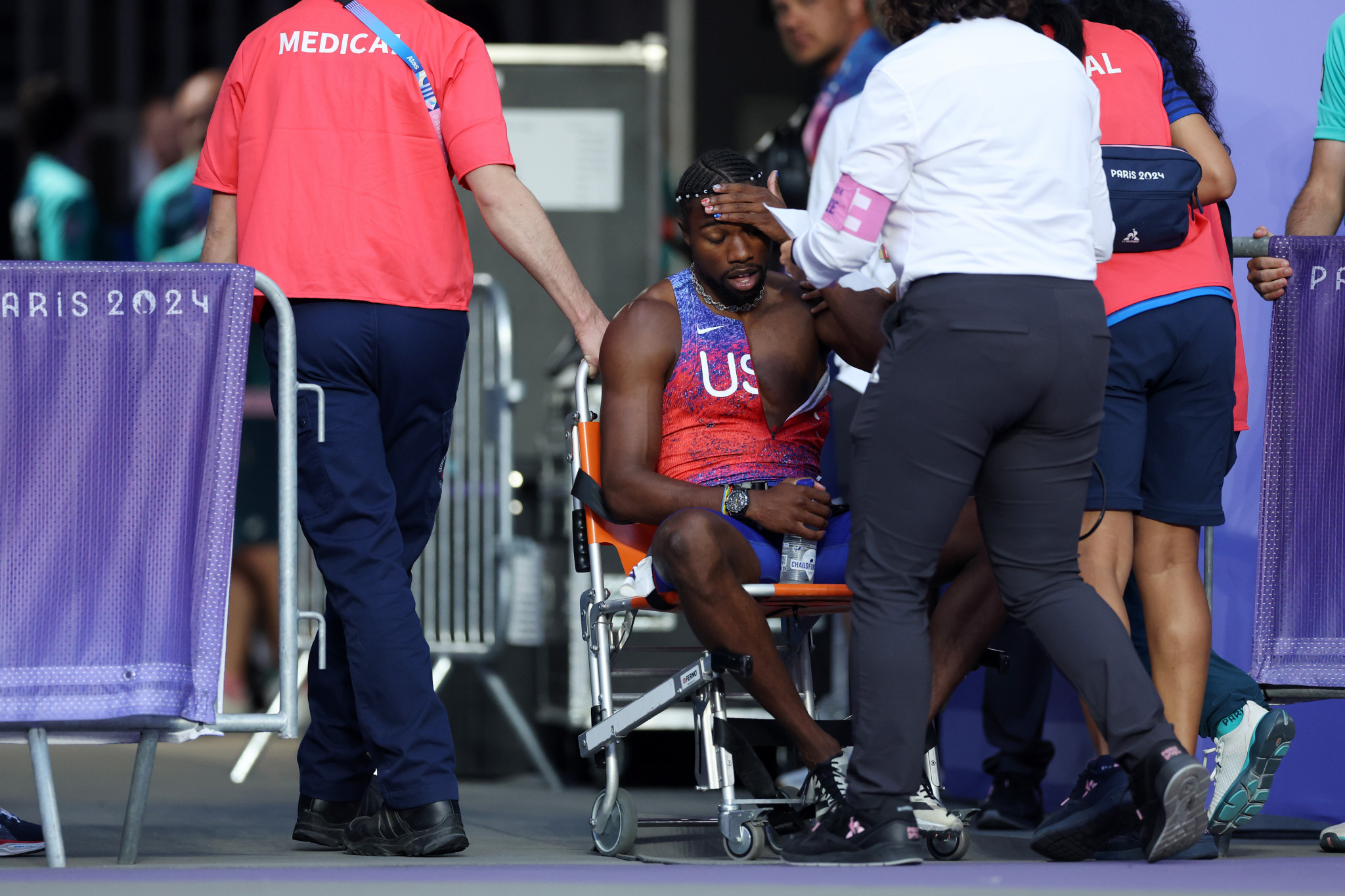 Bronze medalist Noah Lyles of Team United States is taken off the track in a wheelchair after competing in the Men's 200m Final at the Paris 2024 Olympic Games. GETTY IMAGES