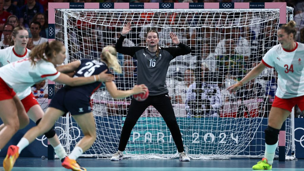 Althea Reinhardt (back) prepares for a shot during the women's semi-final handball match between Norway and Denmark. GETTY IMAGES