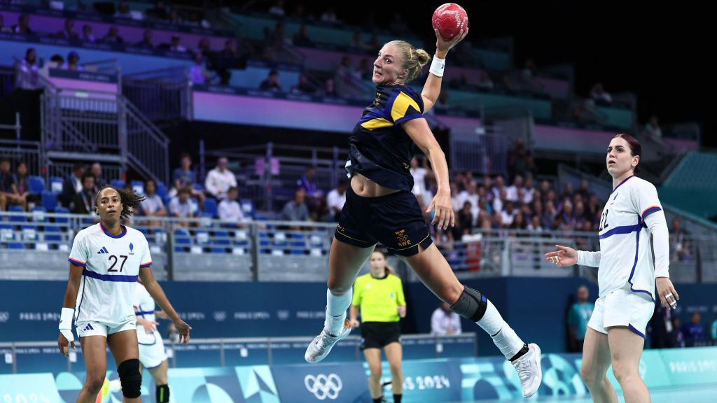 Linn Blohm (C) shoots to score past France's left back #27 Estelle Nze Minko (L) and France's centre back #22 Tamara Horacek during the women's semi-final handball . GETTY IMAGES