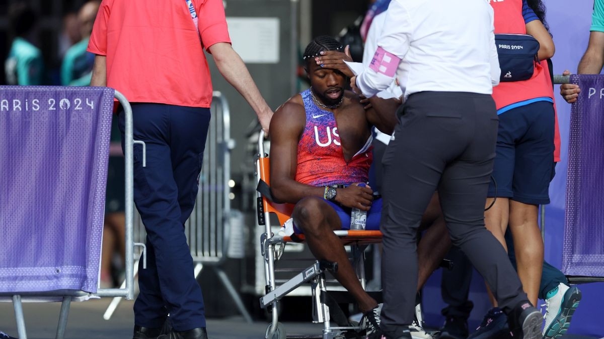 Lyles is removed from the track in a wheelchair after competing in the men's 200 meter final. GETTY IMAGES