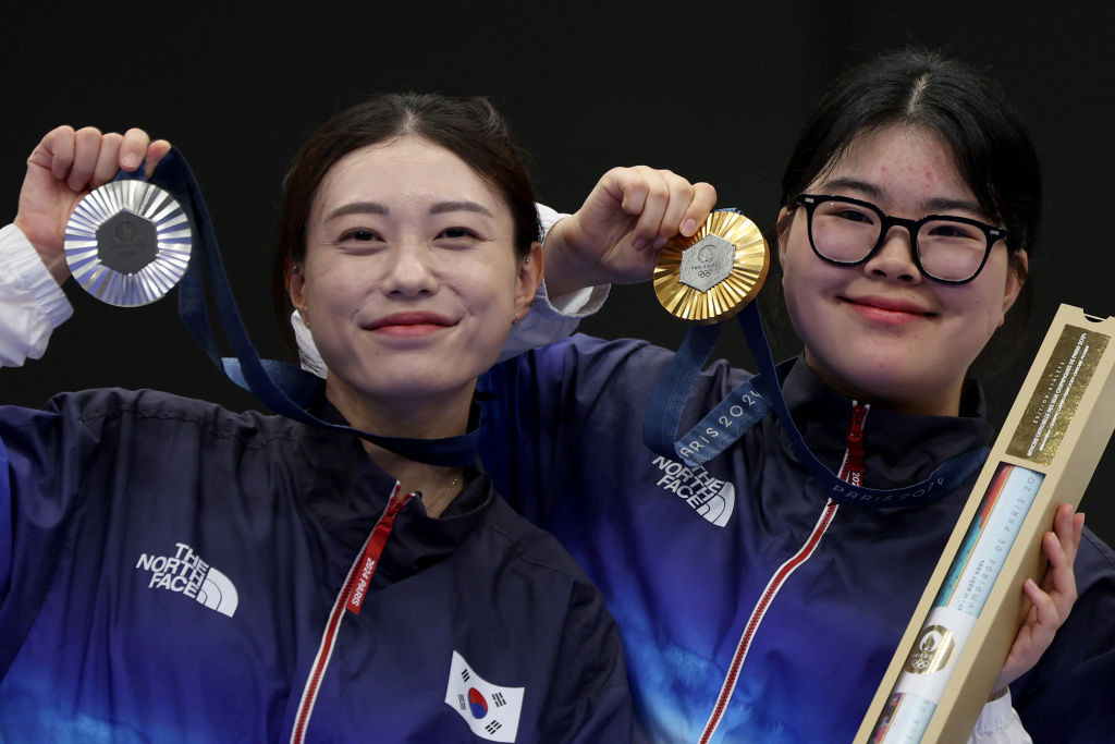 South Korea's Kim Ye-ji and Oh Ye Jin show off their medals from the women's 10m air pistols event. GETTY IMAGES