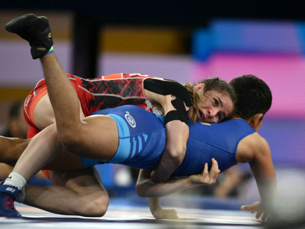 Turkey's Zeynep Yetgil (red) wrestles India's Antim Antim (blue) in their women's freestyle 53kg wrestling  GETTY IMAGES