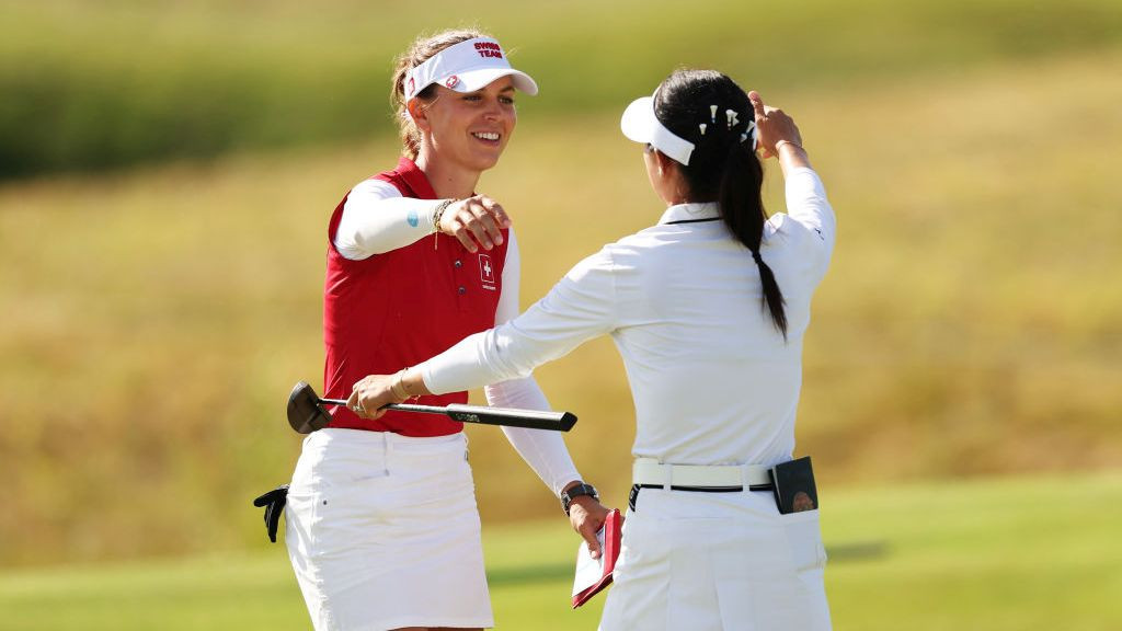 Morgane Metraux of Team Switzerland and Lydia Ko of Team New Zealand embrace . GETTY IMAGES