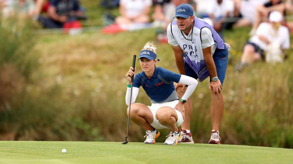 Nelly Korda of Team United States and her caddie, Jason McDede line up a putt on the 18th green. GETTY IMAGES