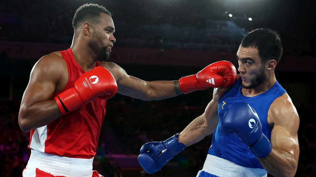 Loren Berto Alfonso Dominguez of Team Azerbaijan punches Lazizbek Mullojonov of Team Uzbekistan. GETTY IMAGES