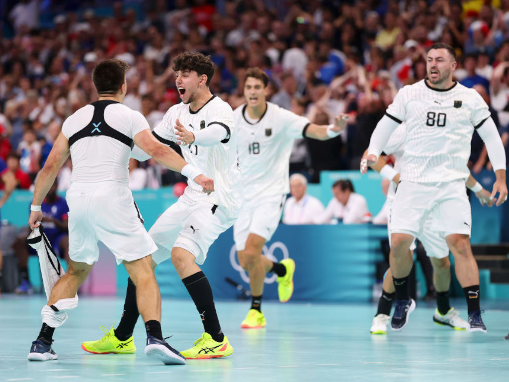 Marko Grgic of Team Germany celebrates winning with teammate Renars Uscins after overtime in the Men's Quarterfinal match getty images