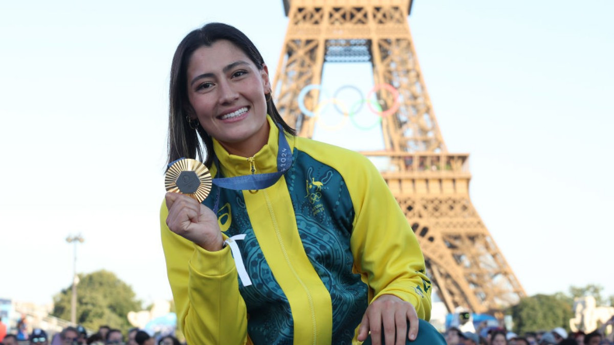 Saya Sakakibara shows off her BMX Racing Olympic gold medal next to the Eiffel Tower. GETTY IMAGES