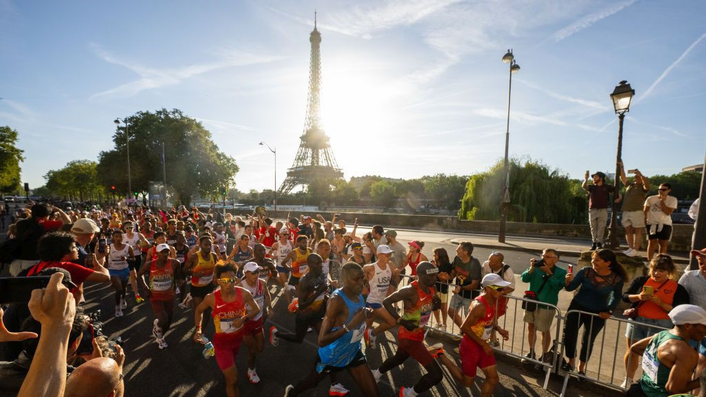 Eliud Kipchoge of Team Kenya, Gabriel Gerald Geay of Team Tanzania, Jie He and Shahoui Yang of Team People's Republic of China run past Eiffel Tower during the Men's Marathon. GETTY IMAGES