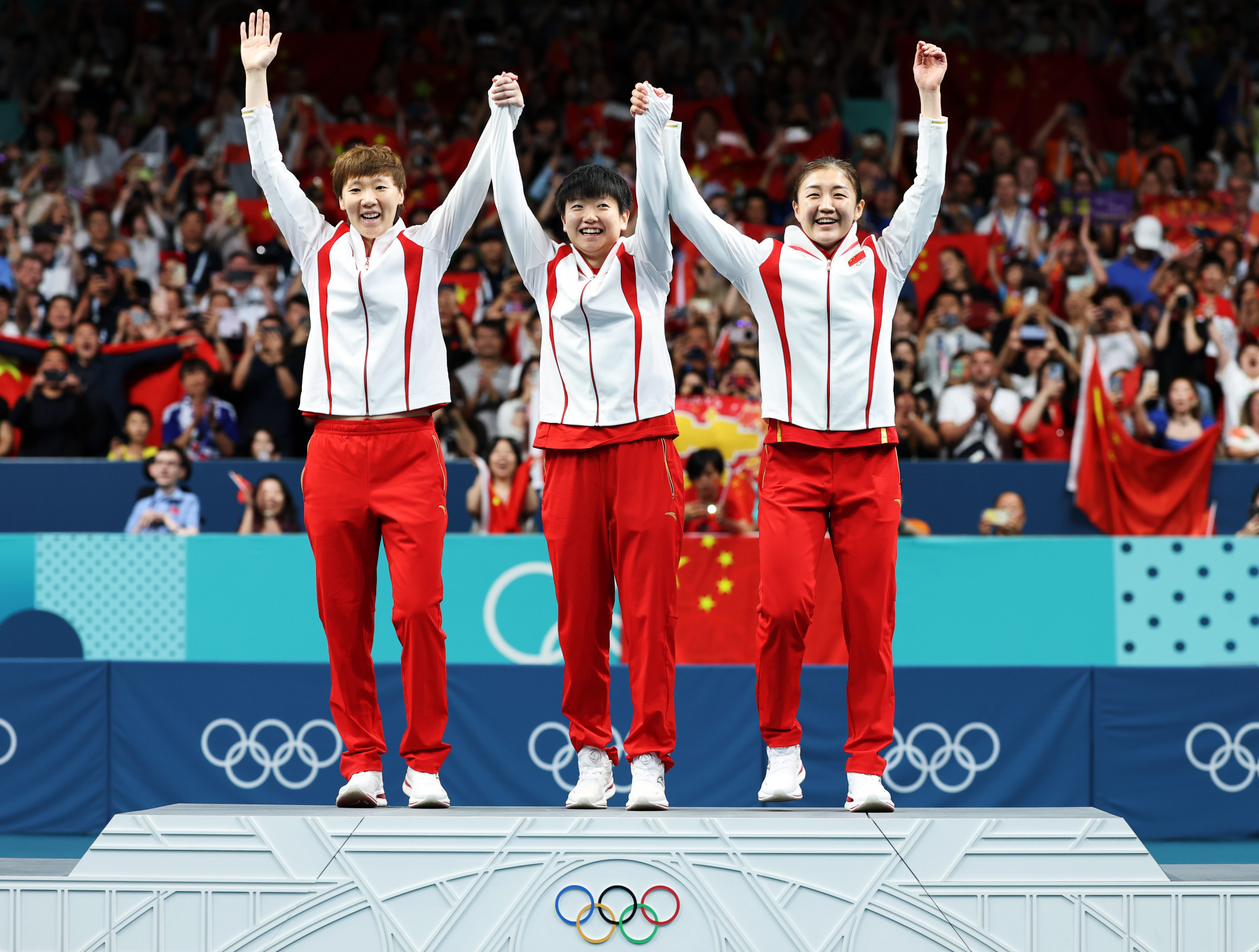 Gold medalists Manyu Wang, Yingsha Sun and Meng Chen of Team People's Republic of China celebrate on the podium at the Table Tennis Women's Team medal ceremony on day fifteen of the Paris 2024 Olympic Games. GETTY IMAGES