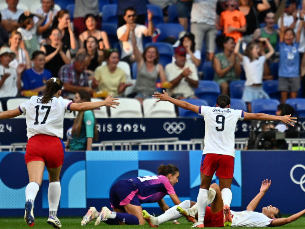 US players celebrate after US' forward #11 Sophia Smith scored in the 95th minute during the women's semi-final football. GETTY IMAGES