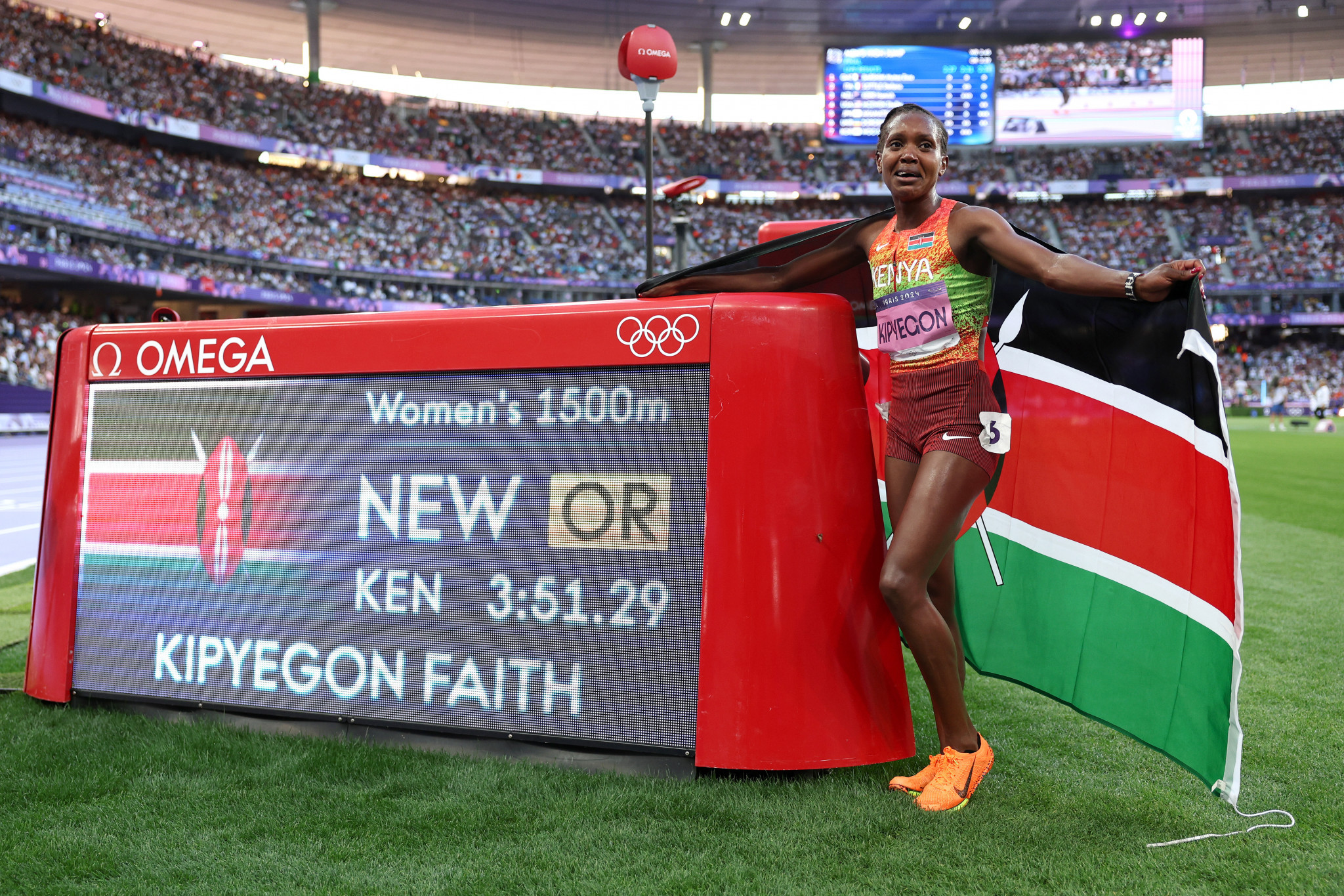 Gold medalist and new Olympic record holder Faith Kipyegon of Team Kenya poses next to her Olympic record in the Women's 1500m Final at the Paris 2024 Olympic Games. GETTY IMAGES