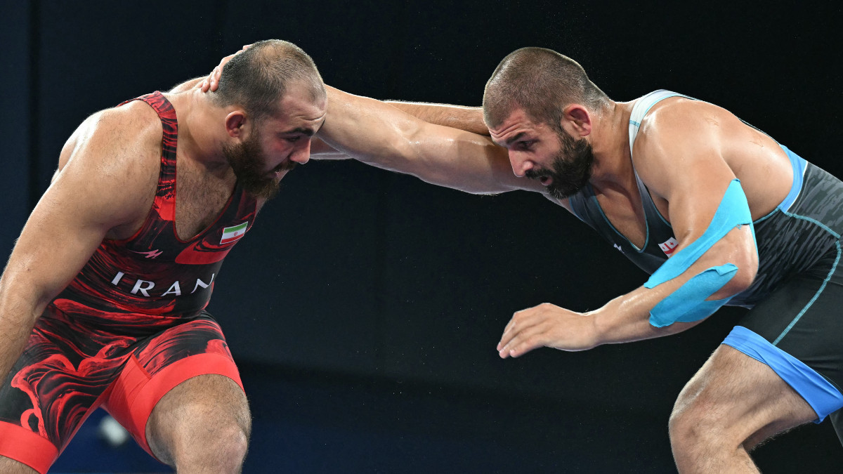 Geno Petriashvili of Georgia (right) against Amir Zare of Iran in the final bout of the men's -130 kg. GETTY IMAGES