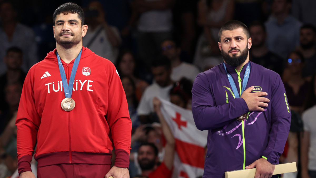 Bronze medallists of the men's -130 kg category Taha Akgyul (left) and Giorgi Meshvildishvili. GETTY IMAGES